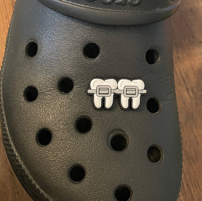 Teeth and Braces Shoe Charm on a croc shoe.