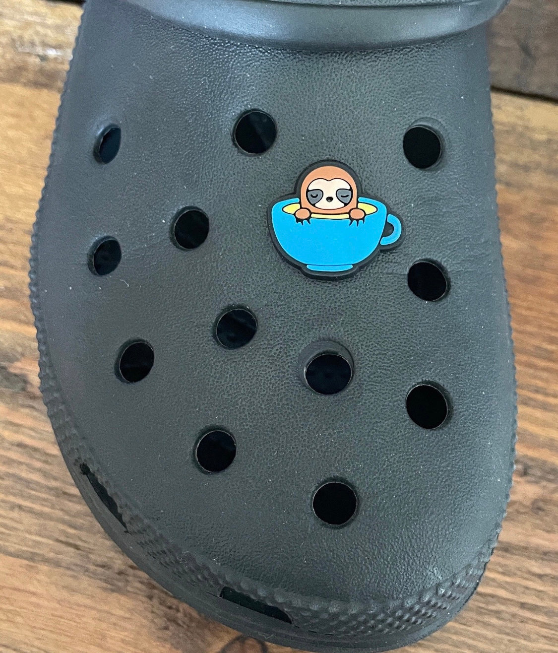 Sloth in a Tea Cup Shoe Charm on a croc shoe.