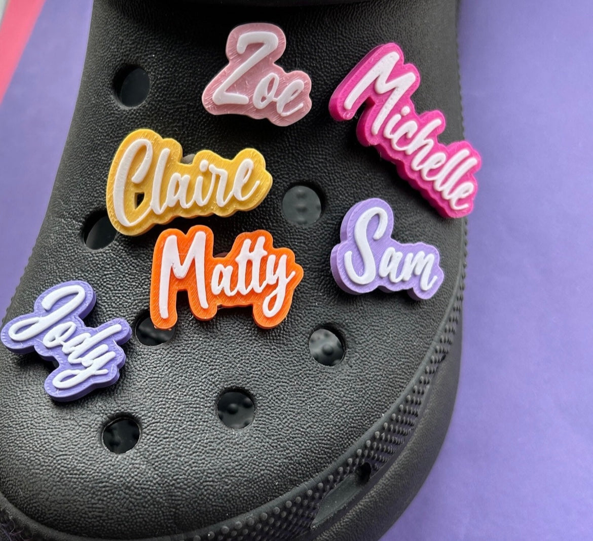 Custom croc charms. Made from PLA plastic. 38 colours available. Example shown on a black croc shoe. 