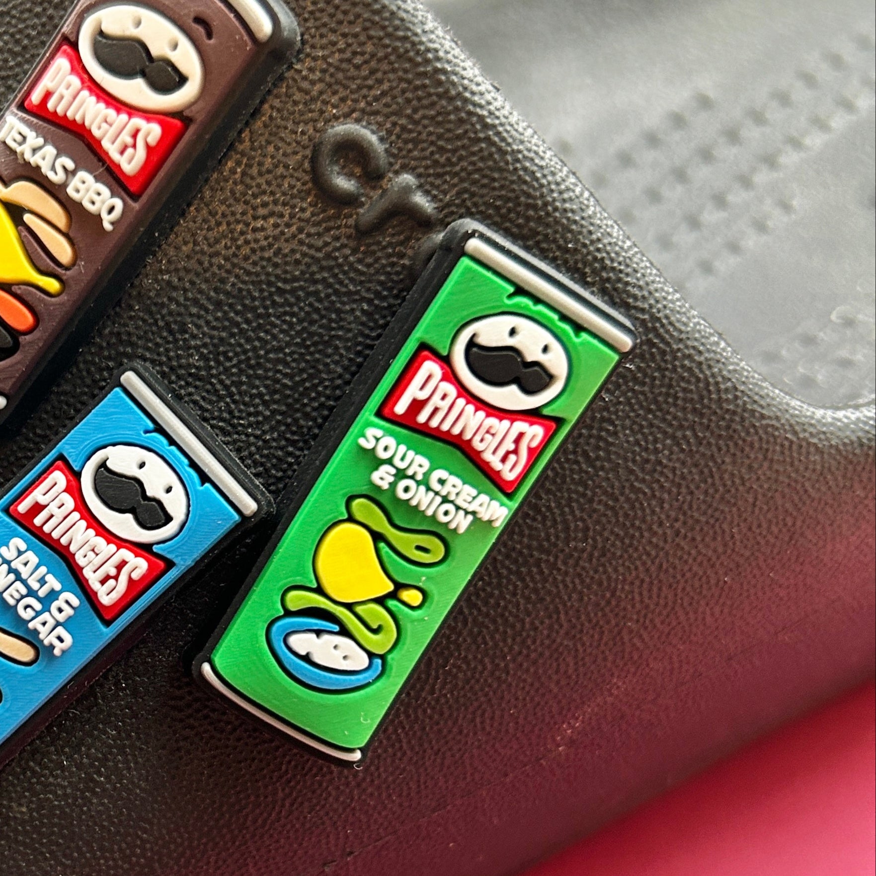 Tube of Crisps - Sour Cream and Onion croc like shoe charm. Shown on a black croc shoe. 