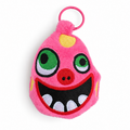A pink plush monster keychain or bag charm with embroidered green eyes, a red nose, white teeth, and a pink key ring, shown on a plain white background.