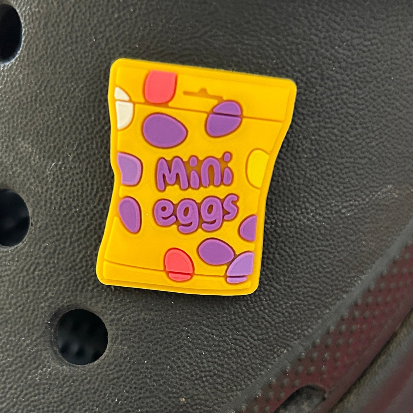 Hard shell Chocolate Eggs. Shown on a black croc shoe. 