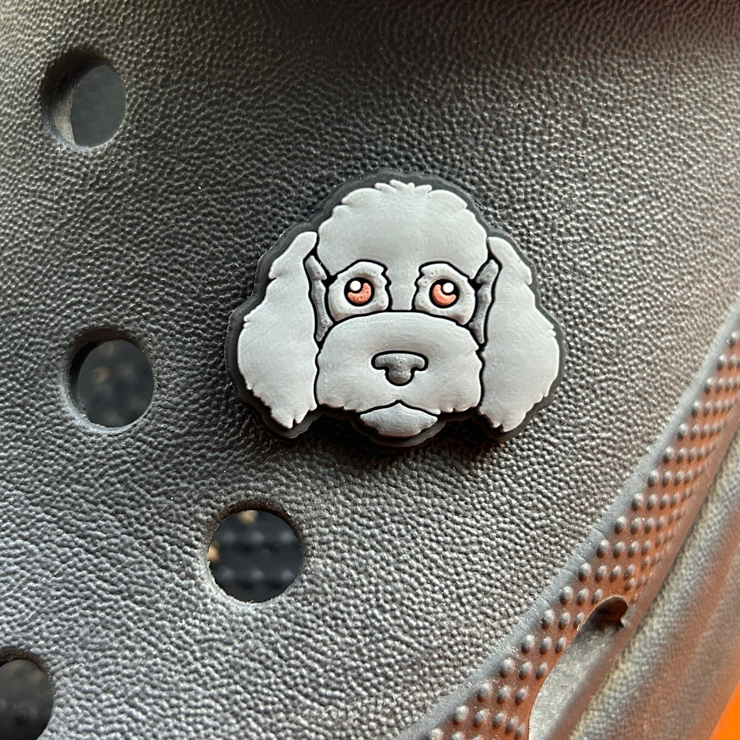 Fluffy Black/Grey Dog croc like shoe charm. Shown on a black croc shoe. 