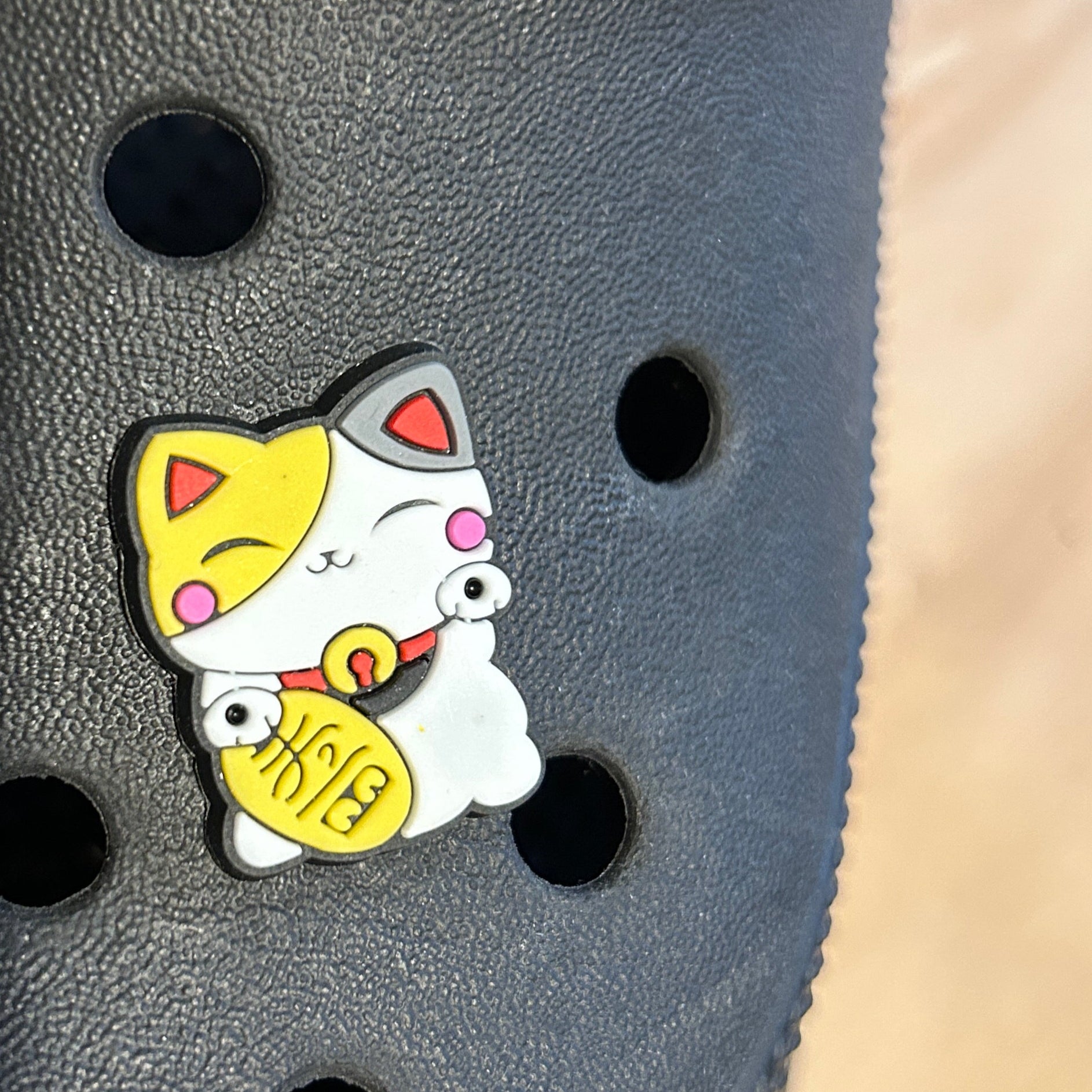 Traditional Lucky Cat croc like shoe charm. Shown on a black croc shoe. 