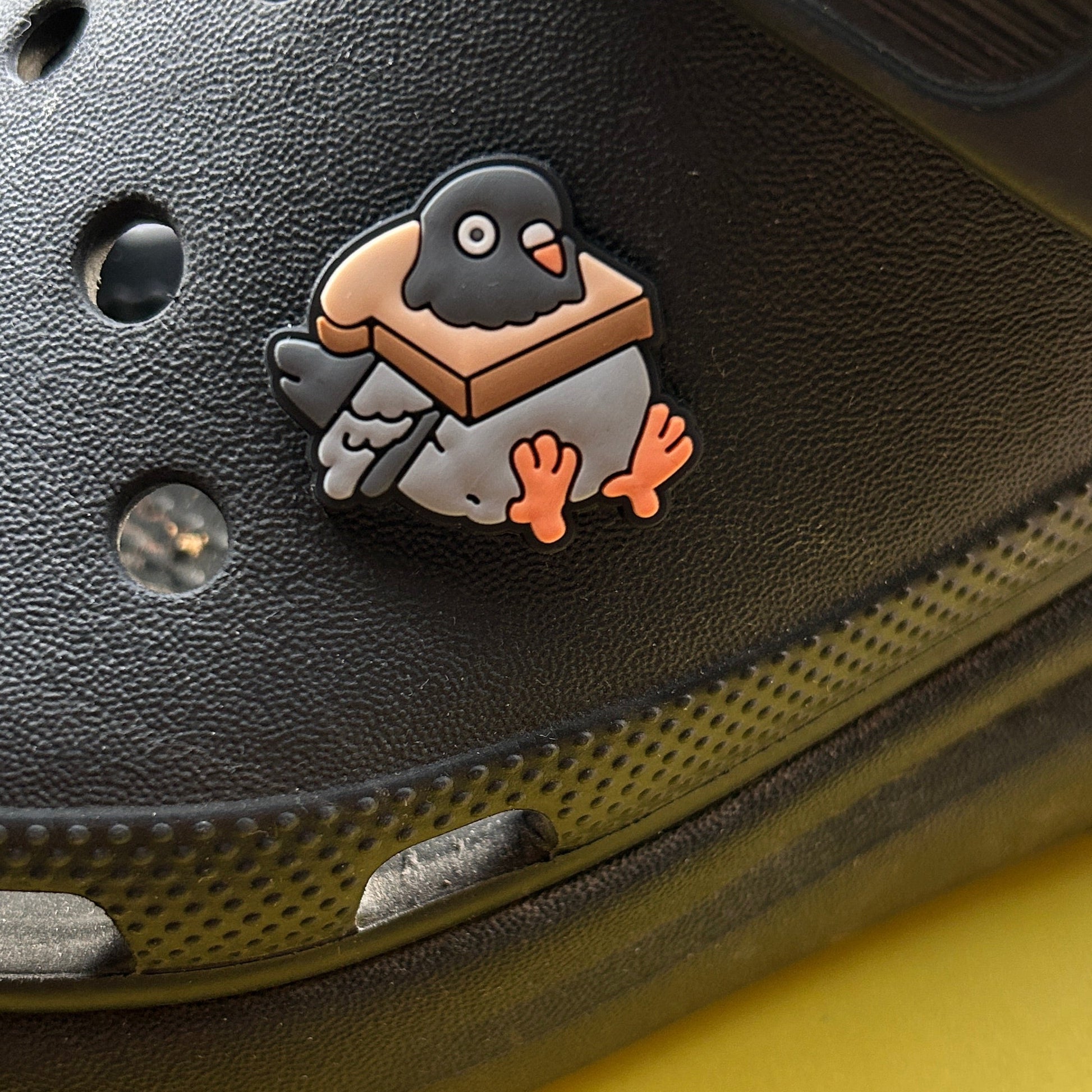 Pigeon in Bread croc like shoe charm. Shown on a black croc shoe. 