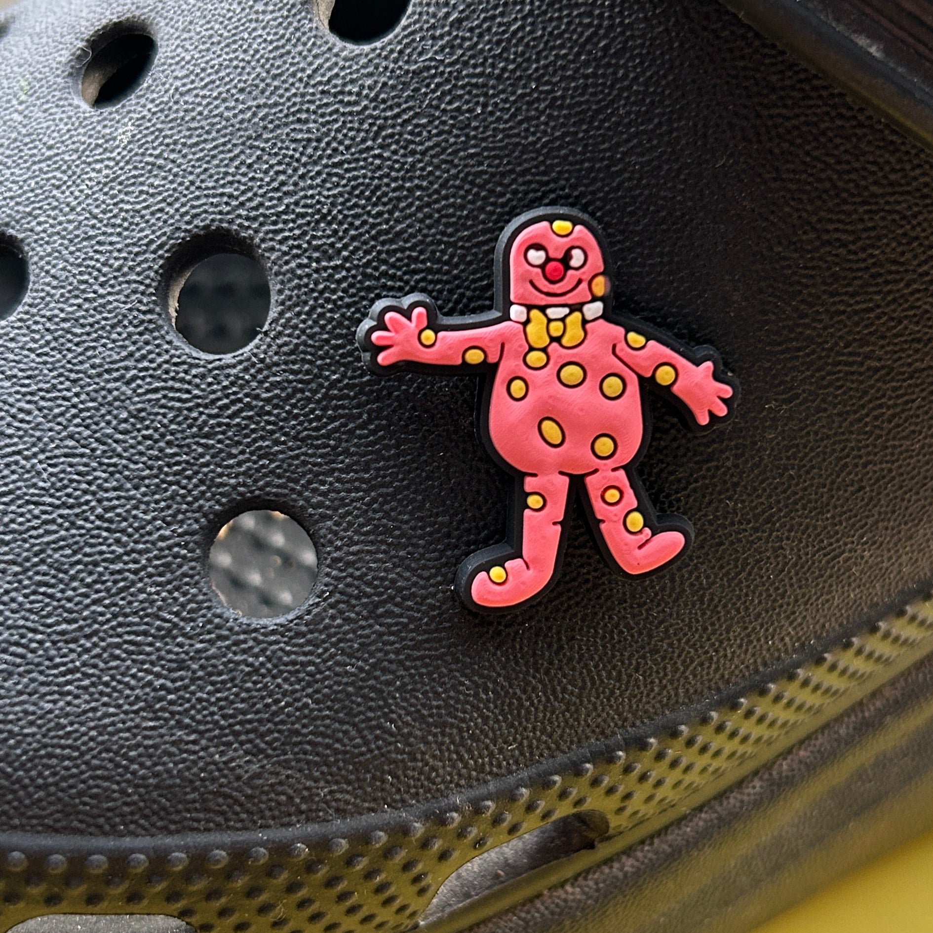 Pink Mr Blobby 90's croc like shoe charm. Shown on a black croc shoe.