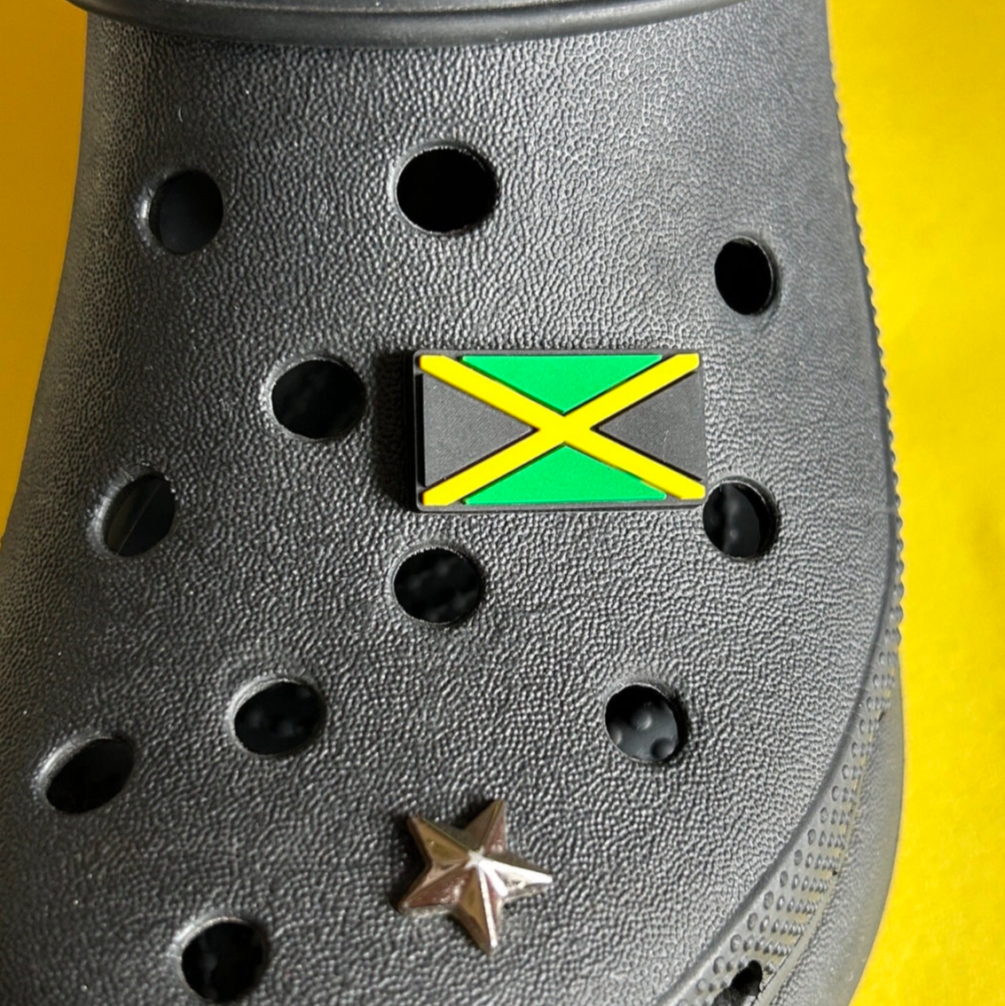 Jamaican flag charm for croc shoes. Modelled on a black croc shoe. 