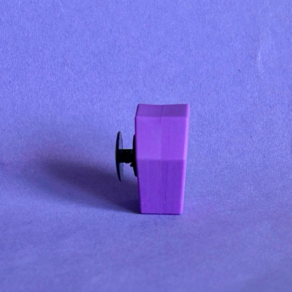 Purple 3D coffin shoe charm for crocs. Upright view.