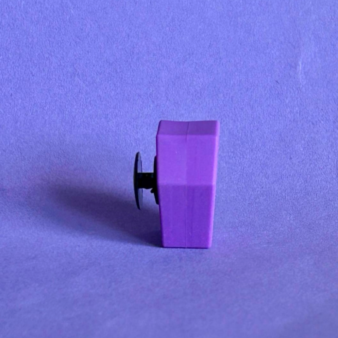 Purple 3D coffin shoe charm for crocs. Upright view.