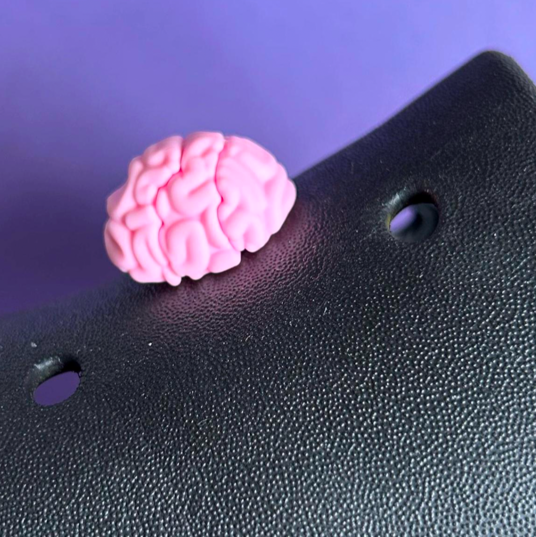 3D Brain croc like shoe charm. Shown on a black croc shoe. 