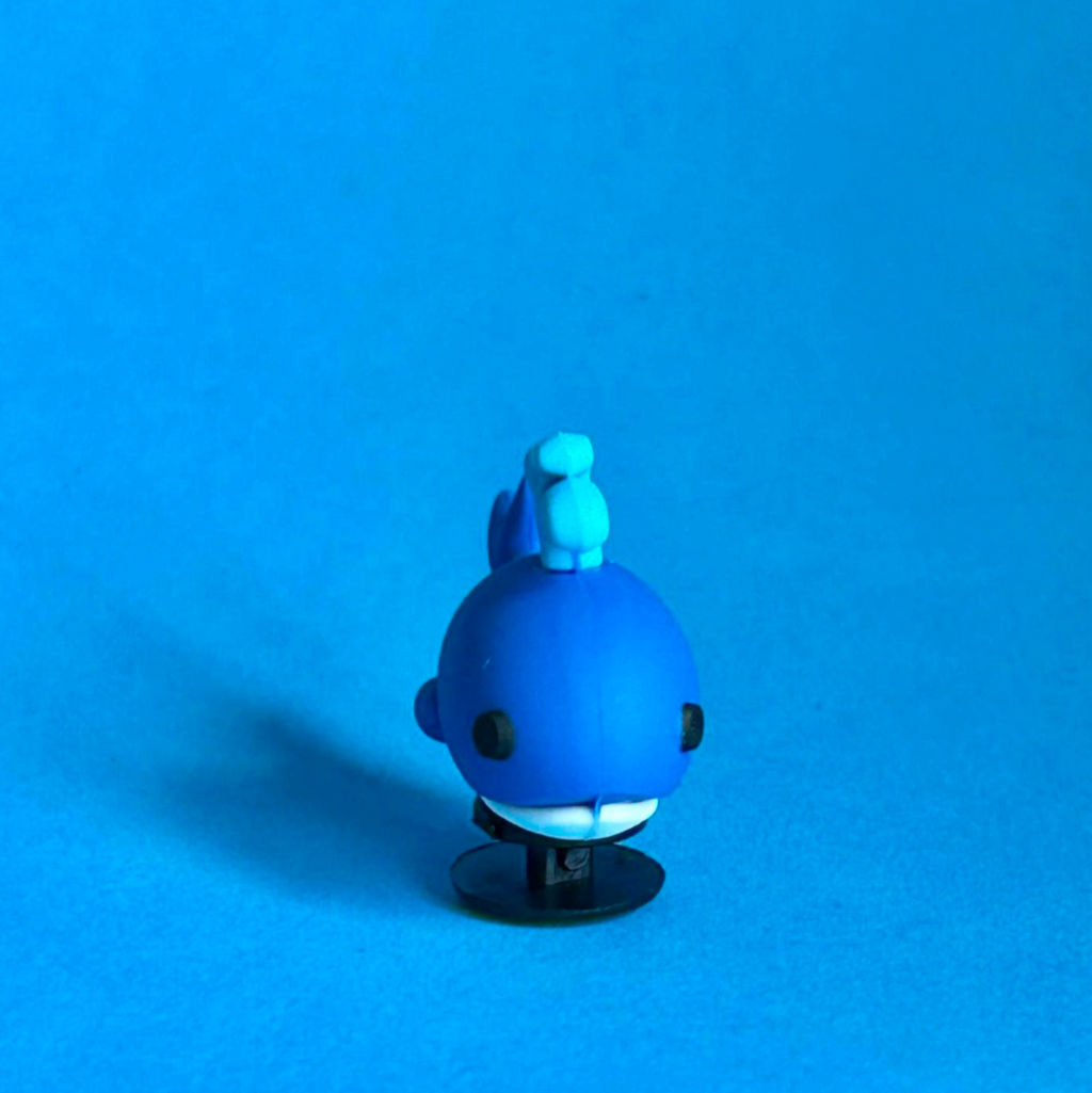 3D Whale croc like shoe charm squirting water. Front view.