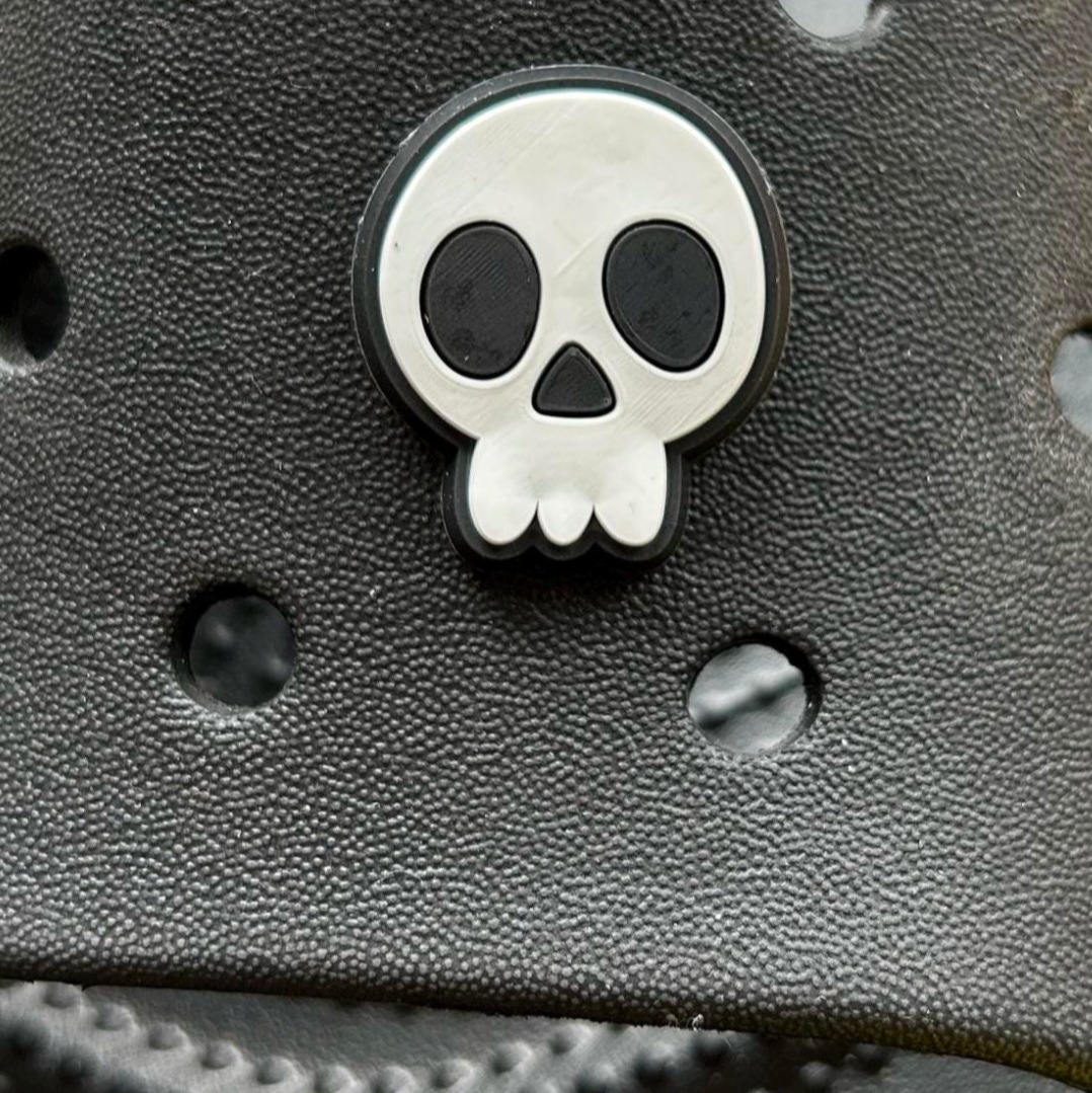 Cartoon Skull croc like shoe charm. Shown on a black croc shoe. 