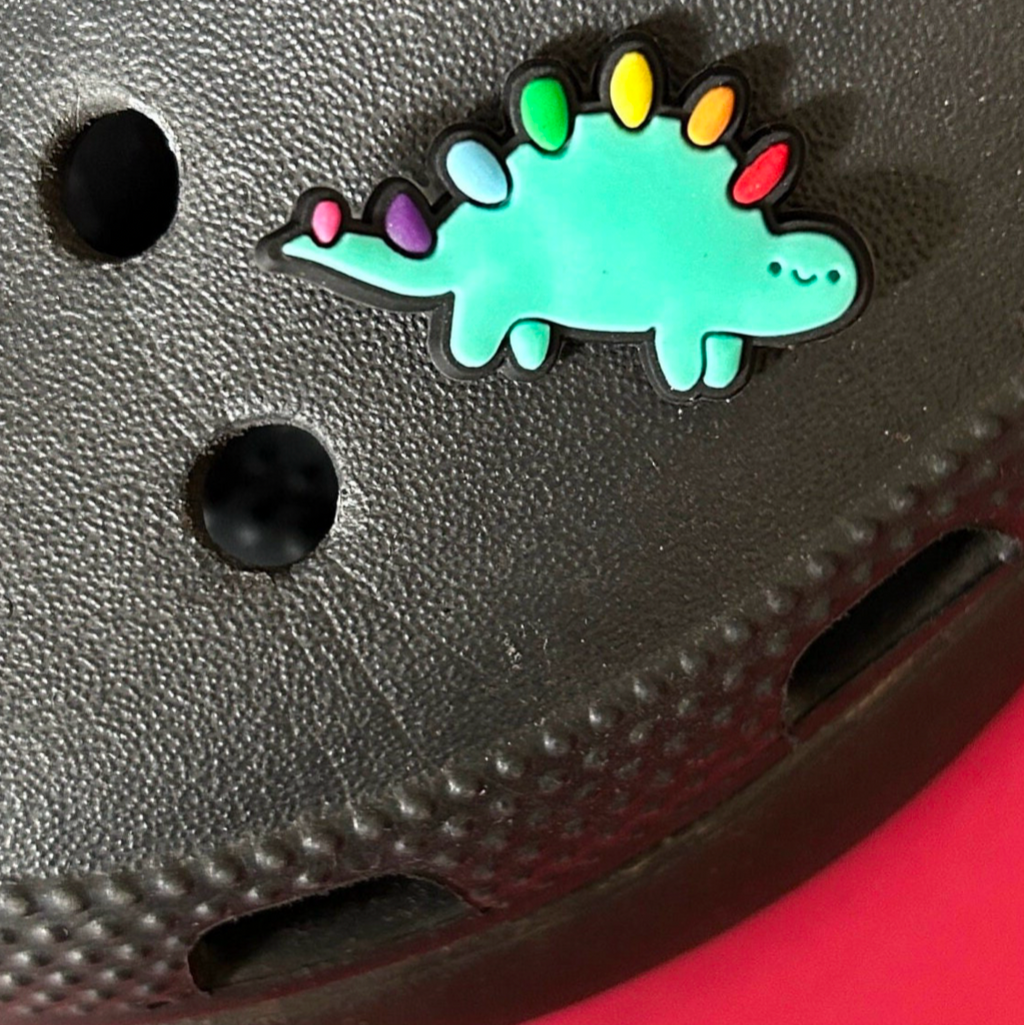 Cute Dinosaur croc like shoe charm. Shown on a black croc shoe. 