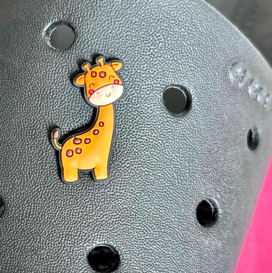 Cute Giraffe croc like shoe charm. Shown on a black croc shoe. 