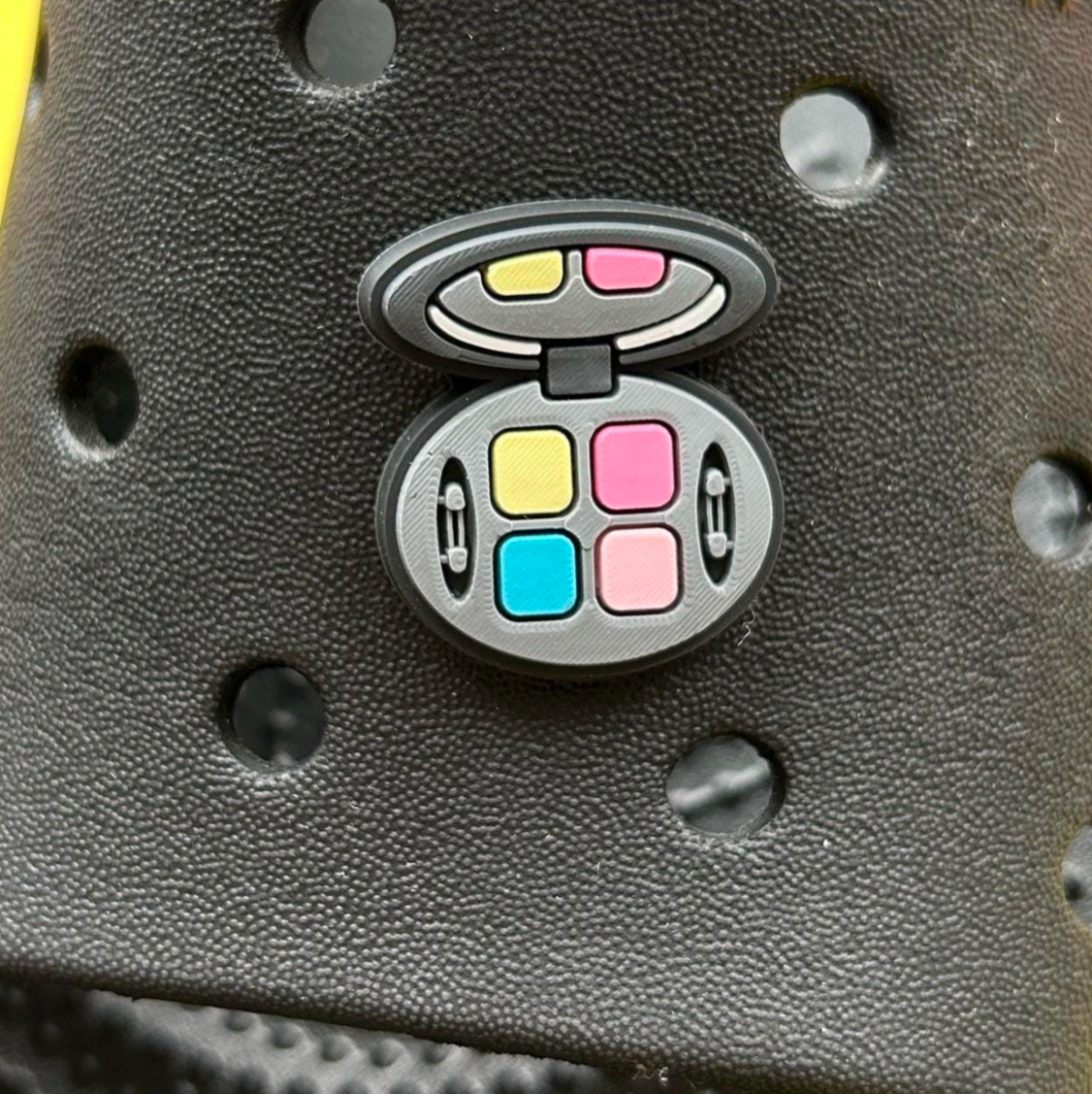 Eyeshadow Compact croc like shoe charm. Shown on a black croc shoe. 