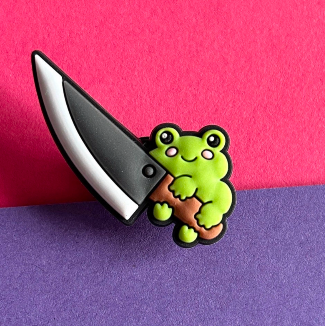 Frog with a big knife croc like shoe charm.