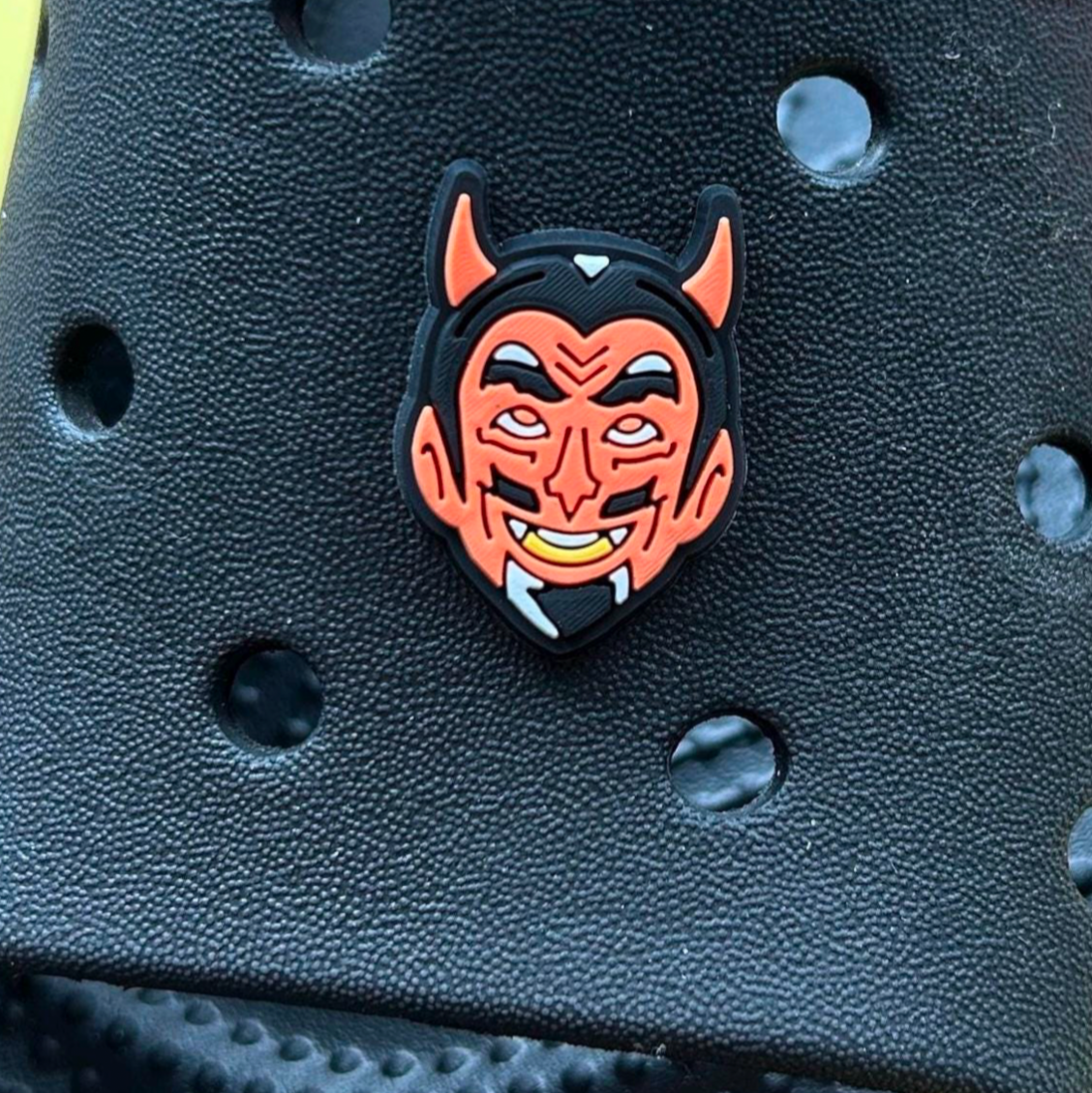 Red retro halloween Devil croc like shoe charm. Shown on a black croc shoe. 