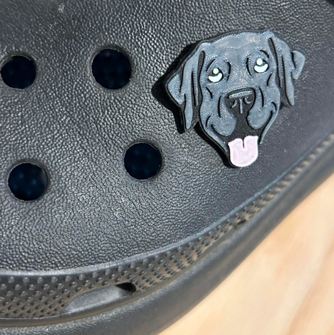 Handmade 3D Printed Black Labrador Dog, croc like shoe charm. Shown on a black croc shoe. Side view. 