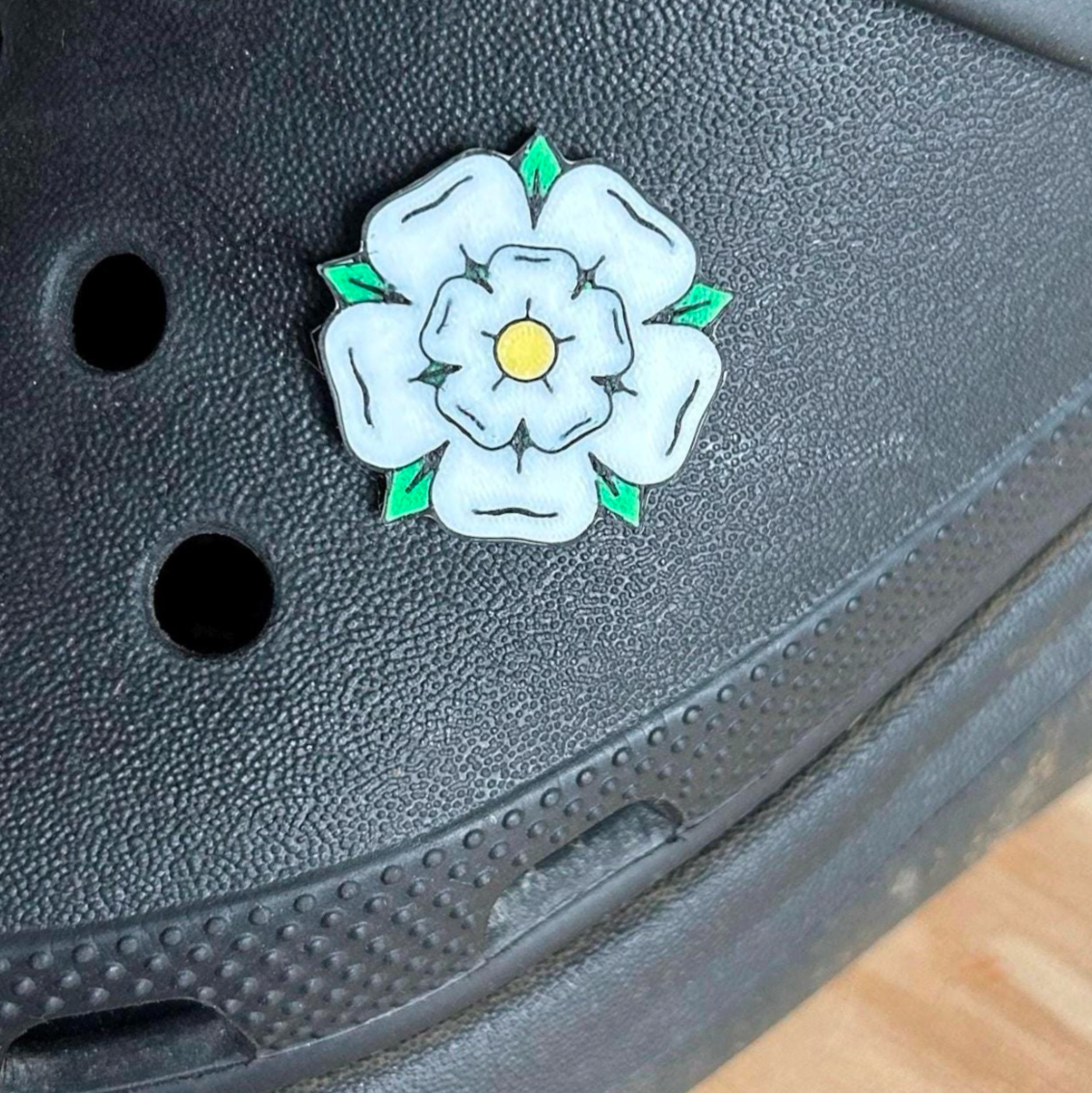 Handmade 3D Printed Yorkshire Rose croc like shoe charm. Shown on a black croc shoe. 