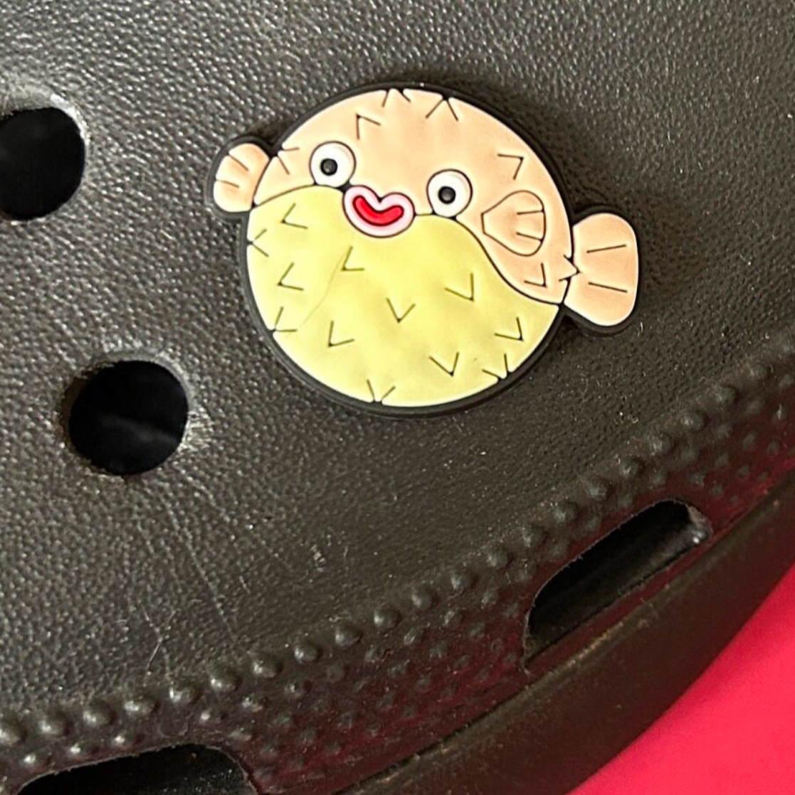 Happy Puffer Fish croc like shoe charm. Shown on a black croc shoe. 