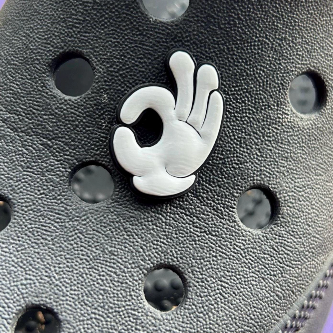 OK White Glove croc like shoe charm. Shown on a black croc. 