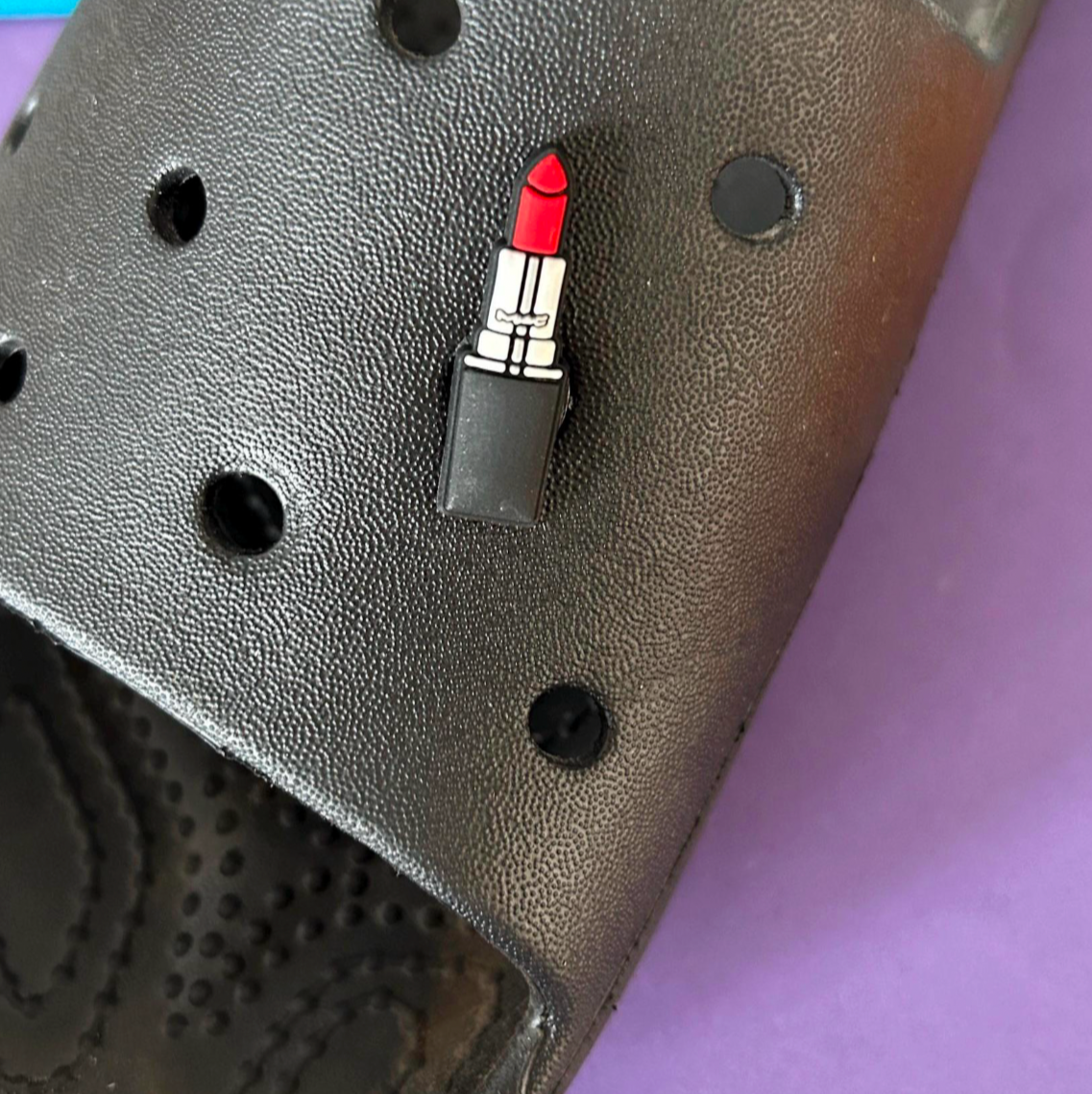 Red Lipstick croc like shoe charm. Shown on a black croc shoe. 