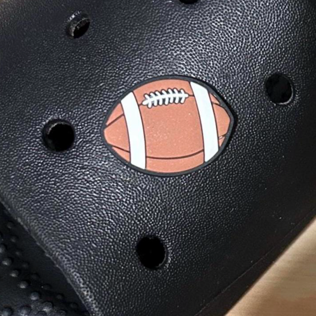 Rugby Ball sport croc like shoe charm. Shown on a black croc shoe. 