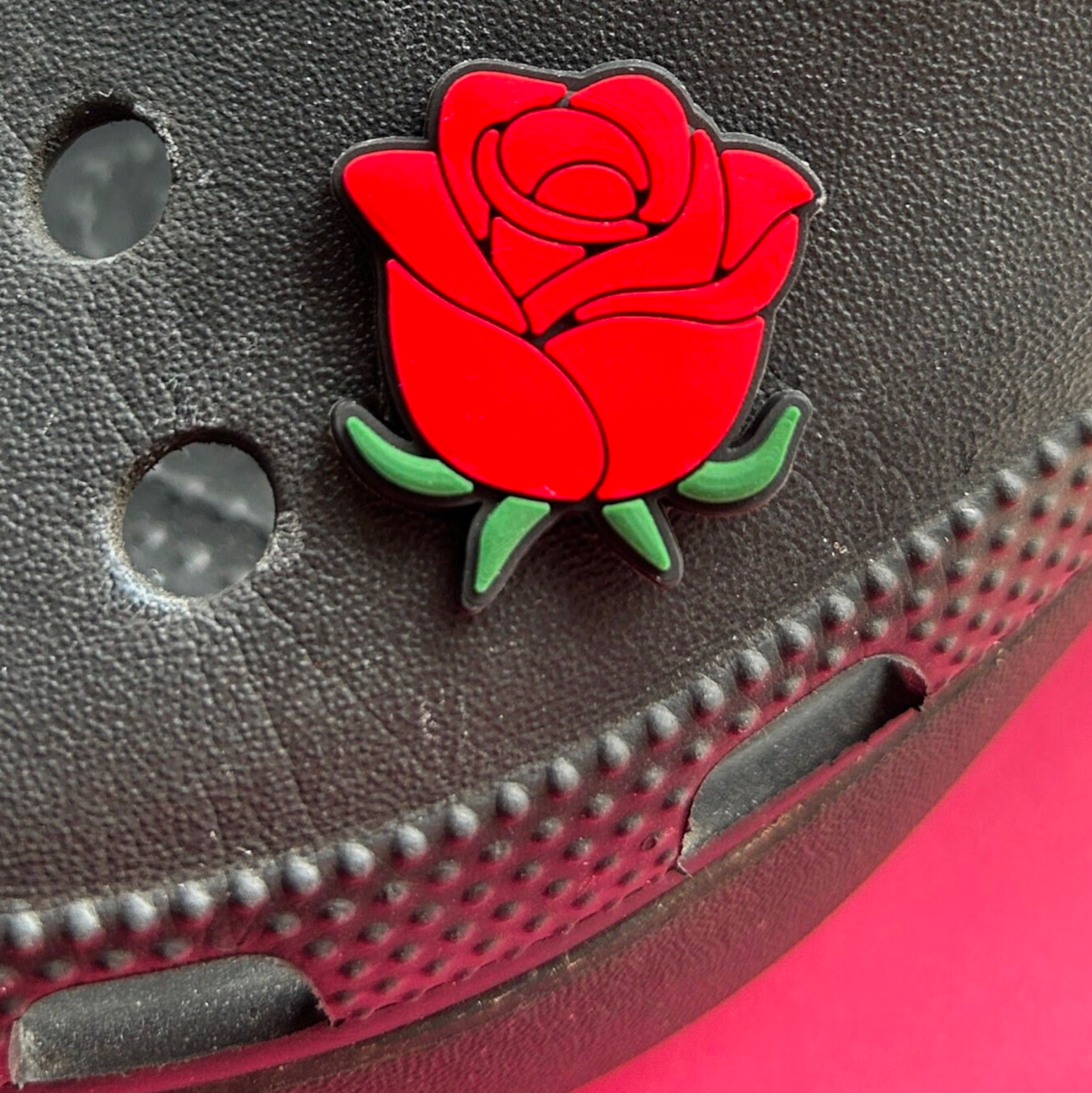 Single Rose croc like shoe charm. Shown on a black croc shoe.