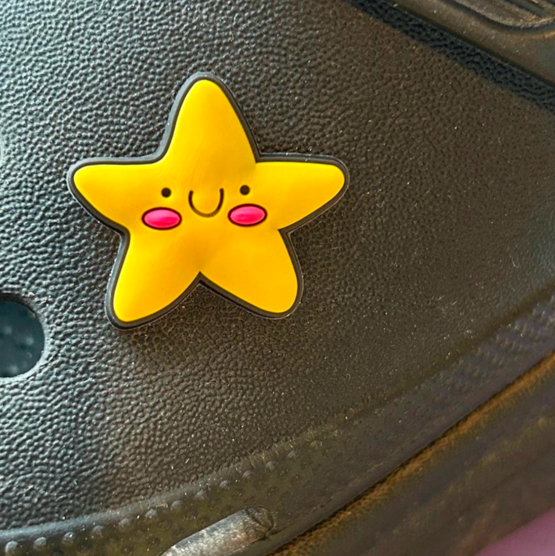 Happy Star croc like shoe charm. Shown on a black croc shoe. 