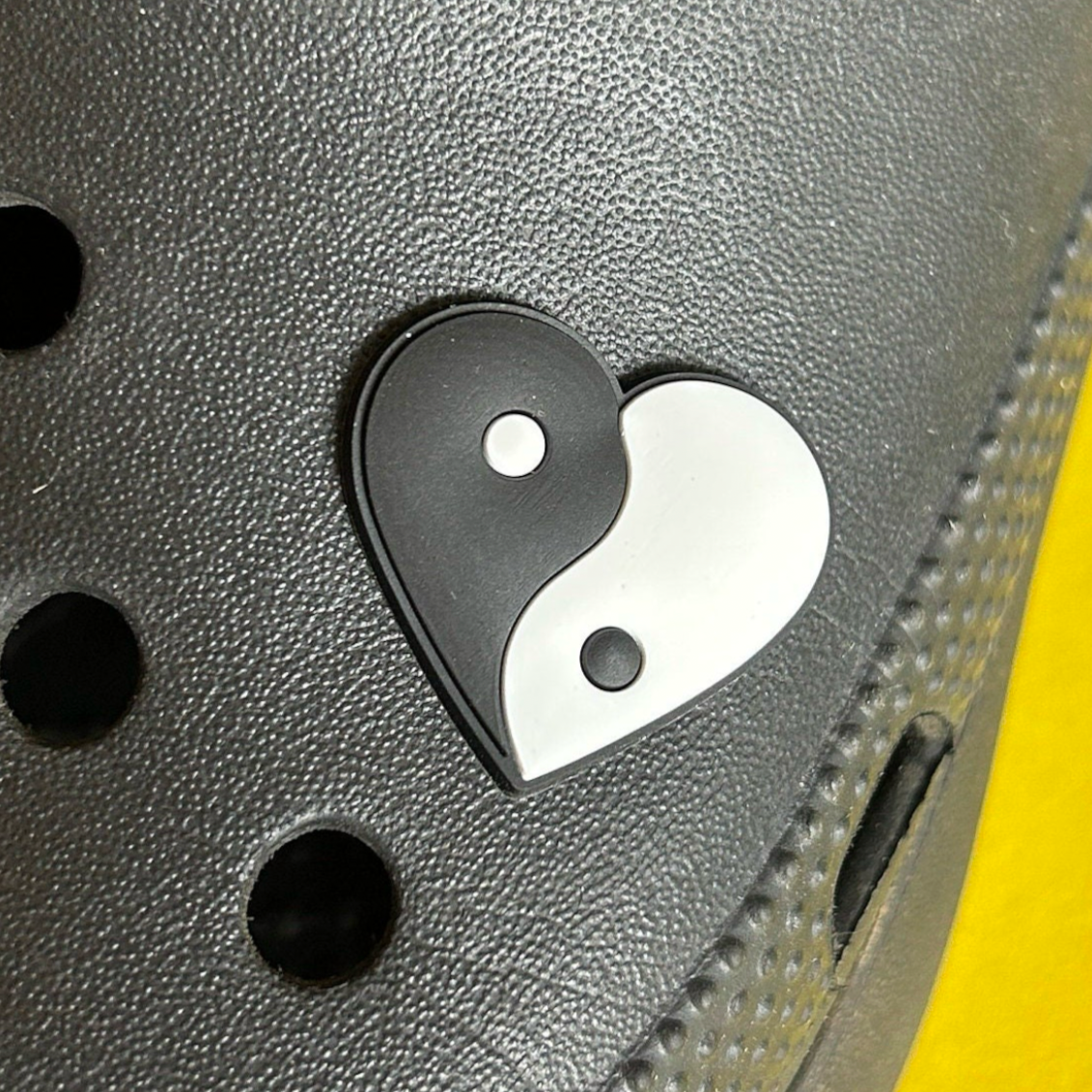 Black and White Yin Yang Heart croc like shoe charm. Shown on a black croc shoe. 