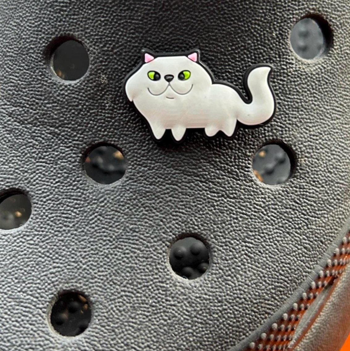 White Cat croc like shoe charm. Shown on a black croc shoe. 