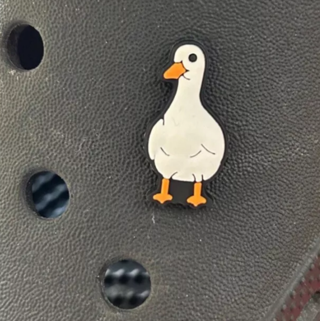 White Goose croc like shoe charm, shown on a black croc shoe. 