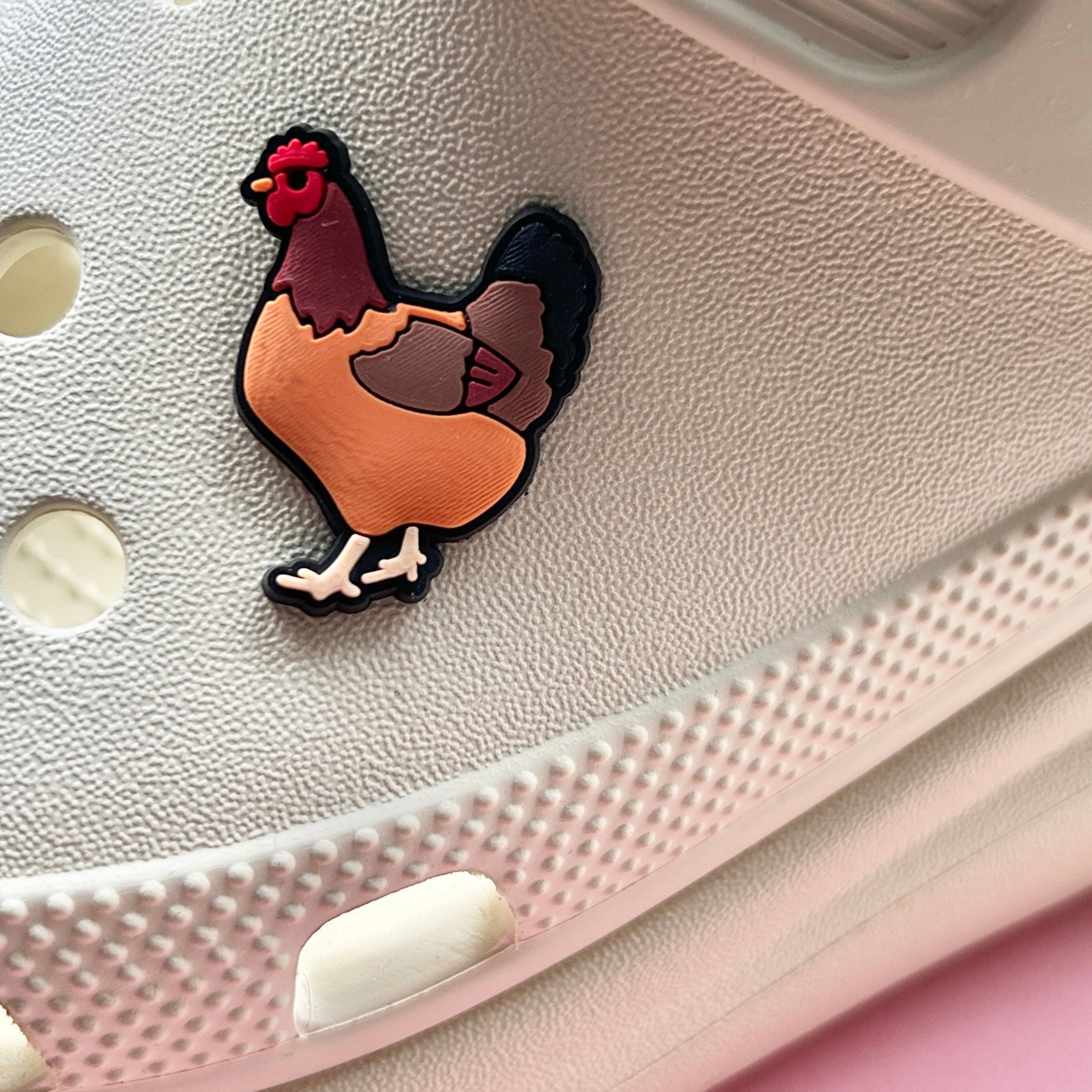 Ginger Chicken croc like shoe charm. Shown on a cream croc shoe. 