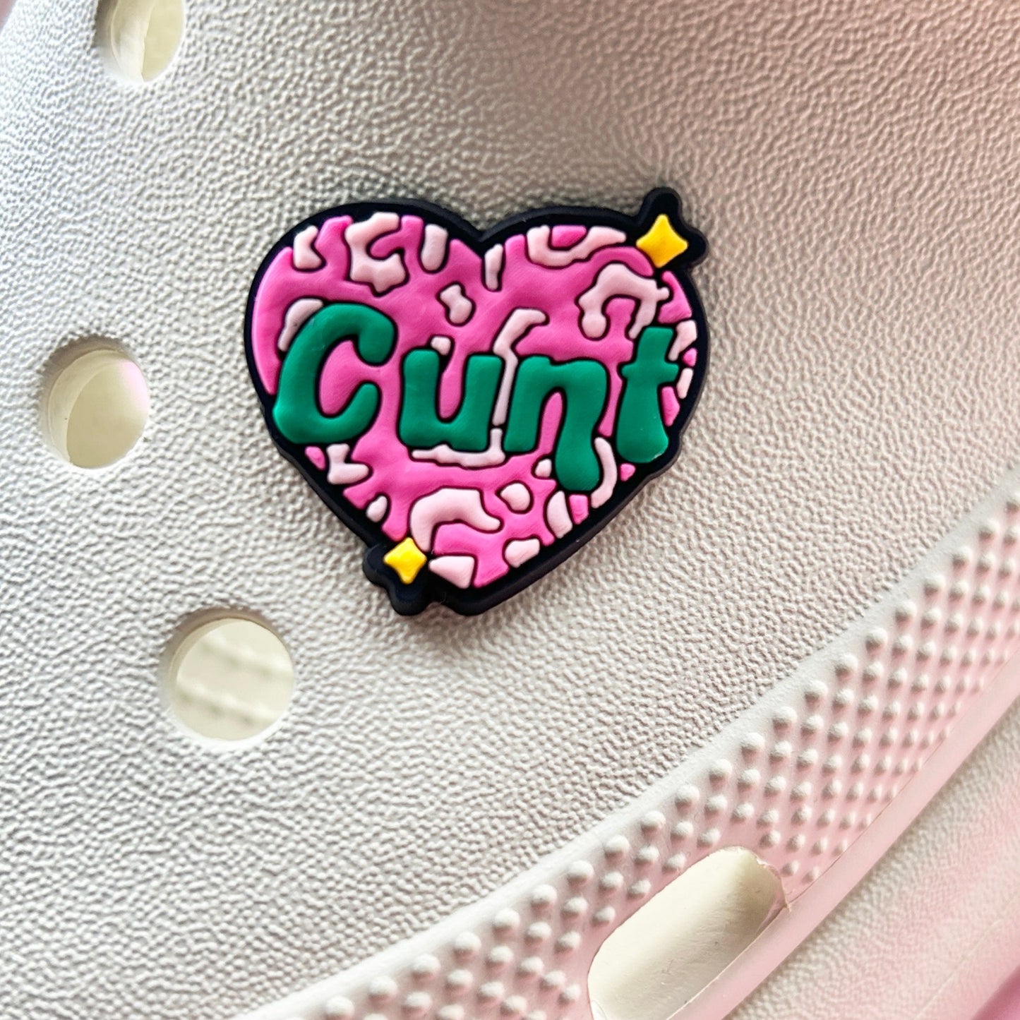 Offensive Pink Cu*t Heart croc like shoe charm. Shoes on a cream croc shoe. 