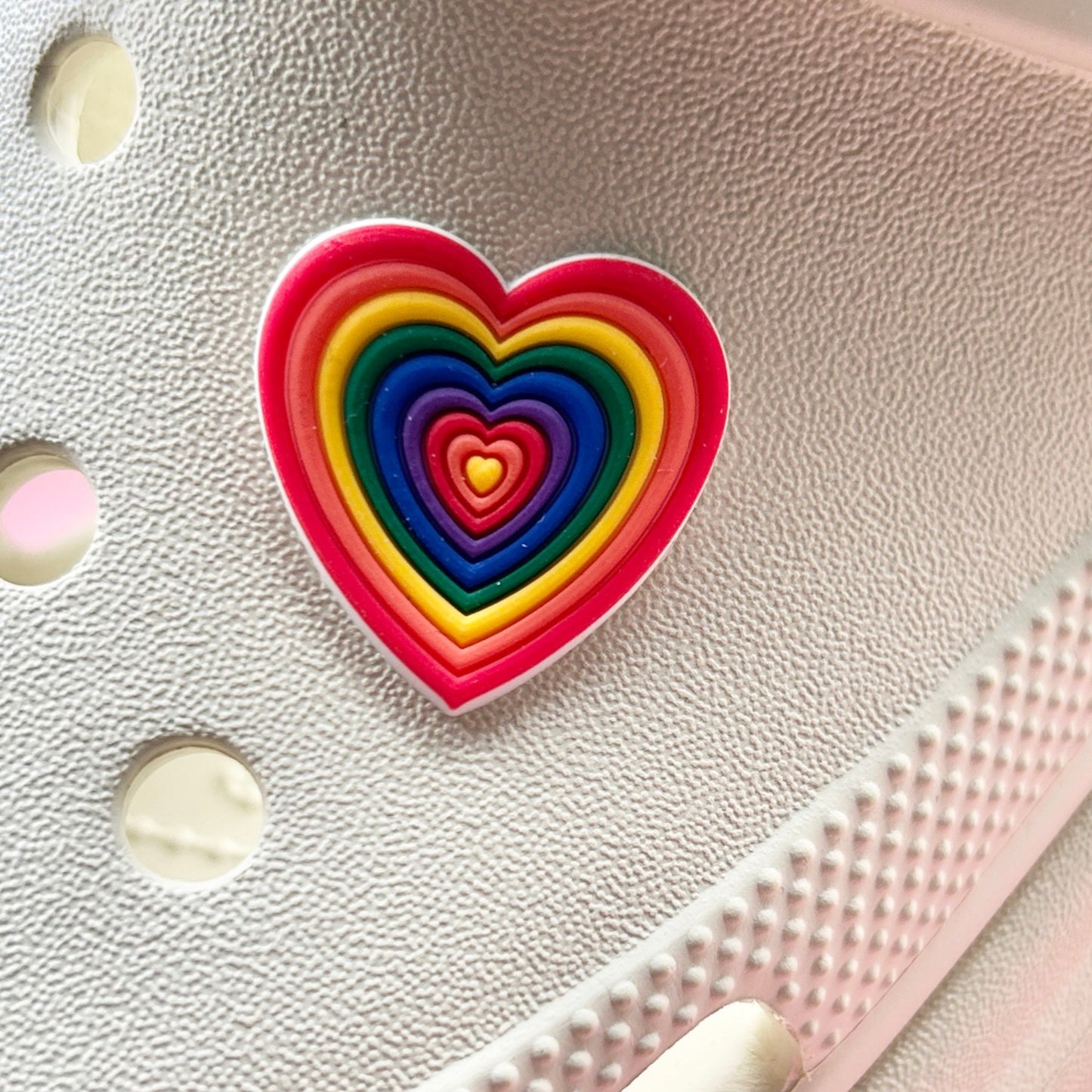 Rainbow Heart croc like shoe charm. Shown on a cream shoe.