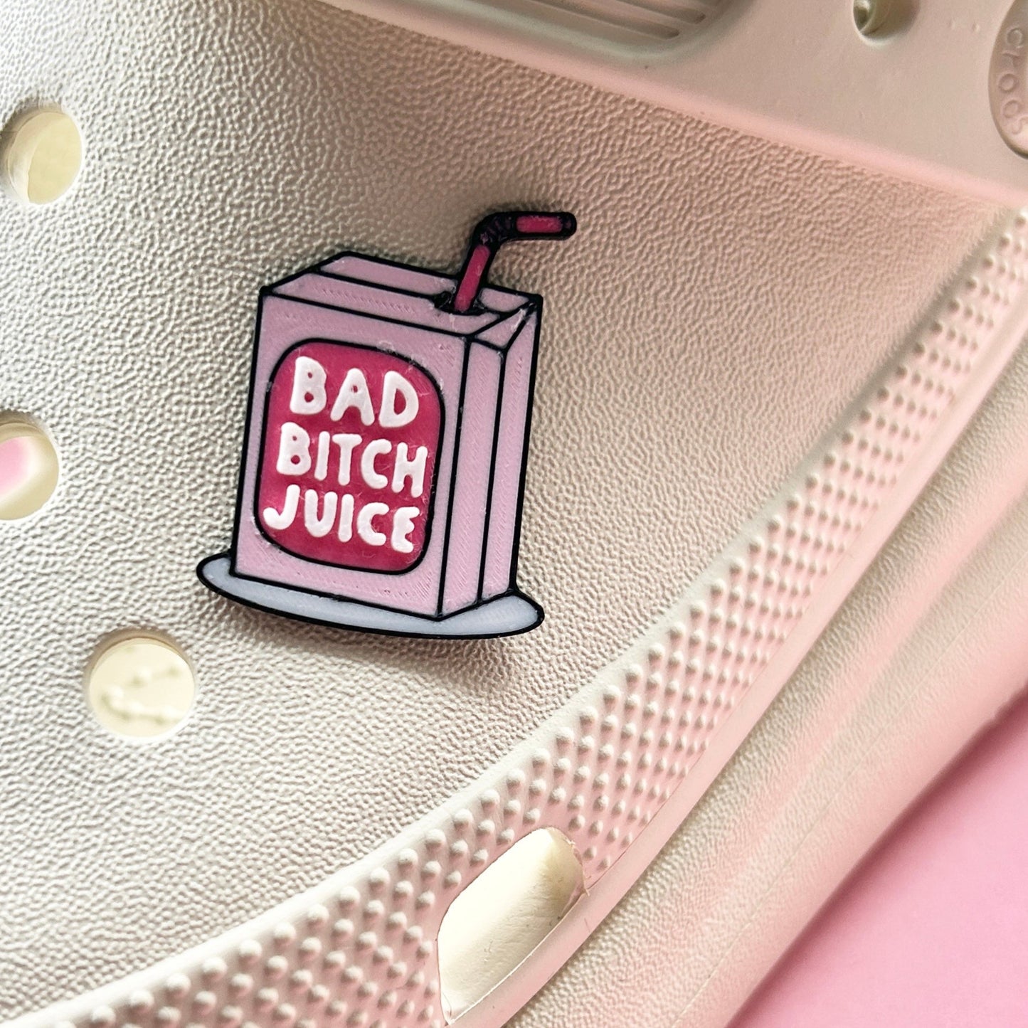 Handmade Bad Bitch Juice 3D Printed charm. Shown on a cream shoe. 