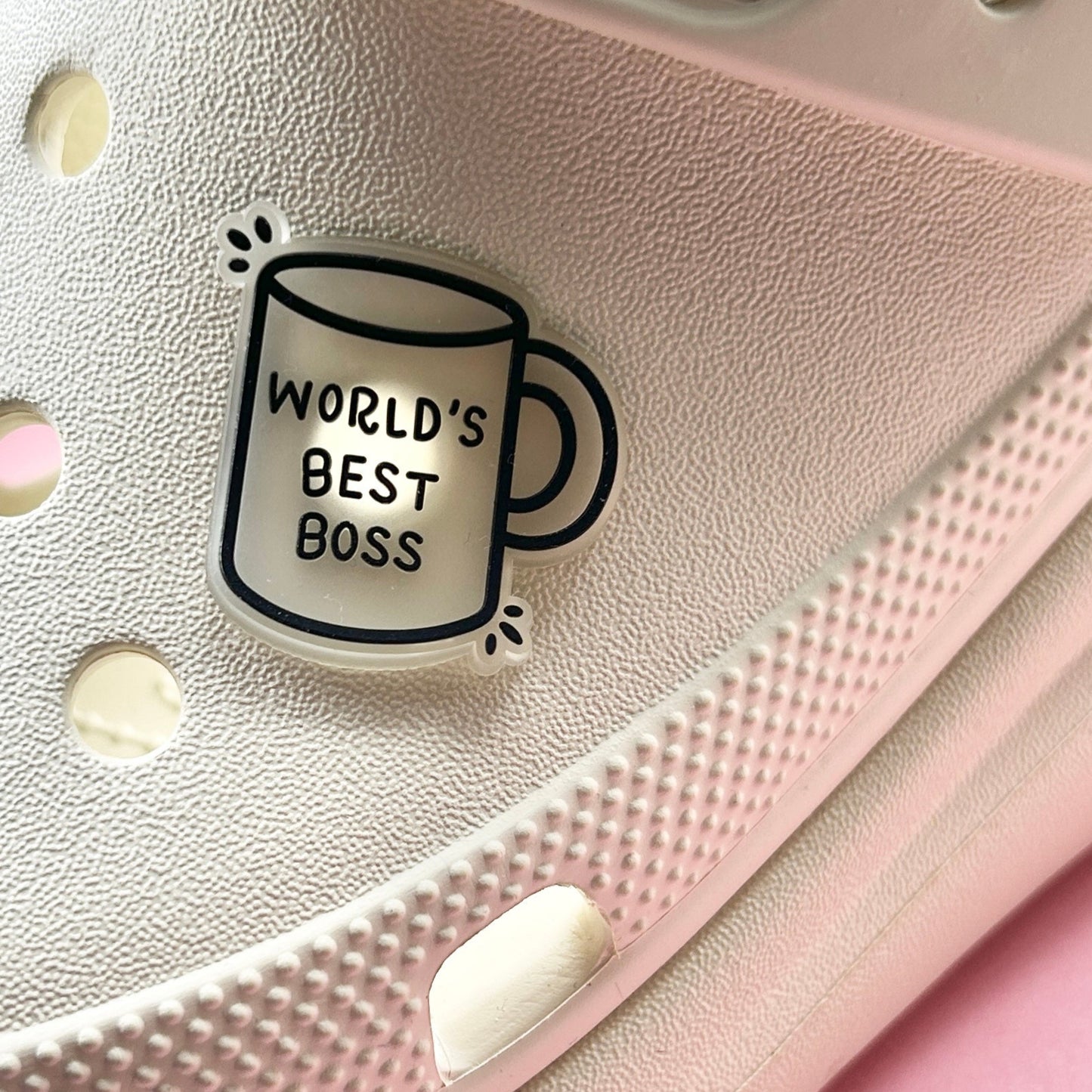 Glow in the Dark Worlds Best Boss Mug croc like shoe charm. Shown on a cream croc shoe.