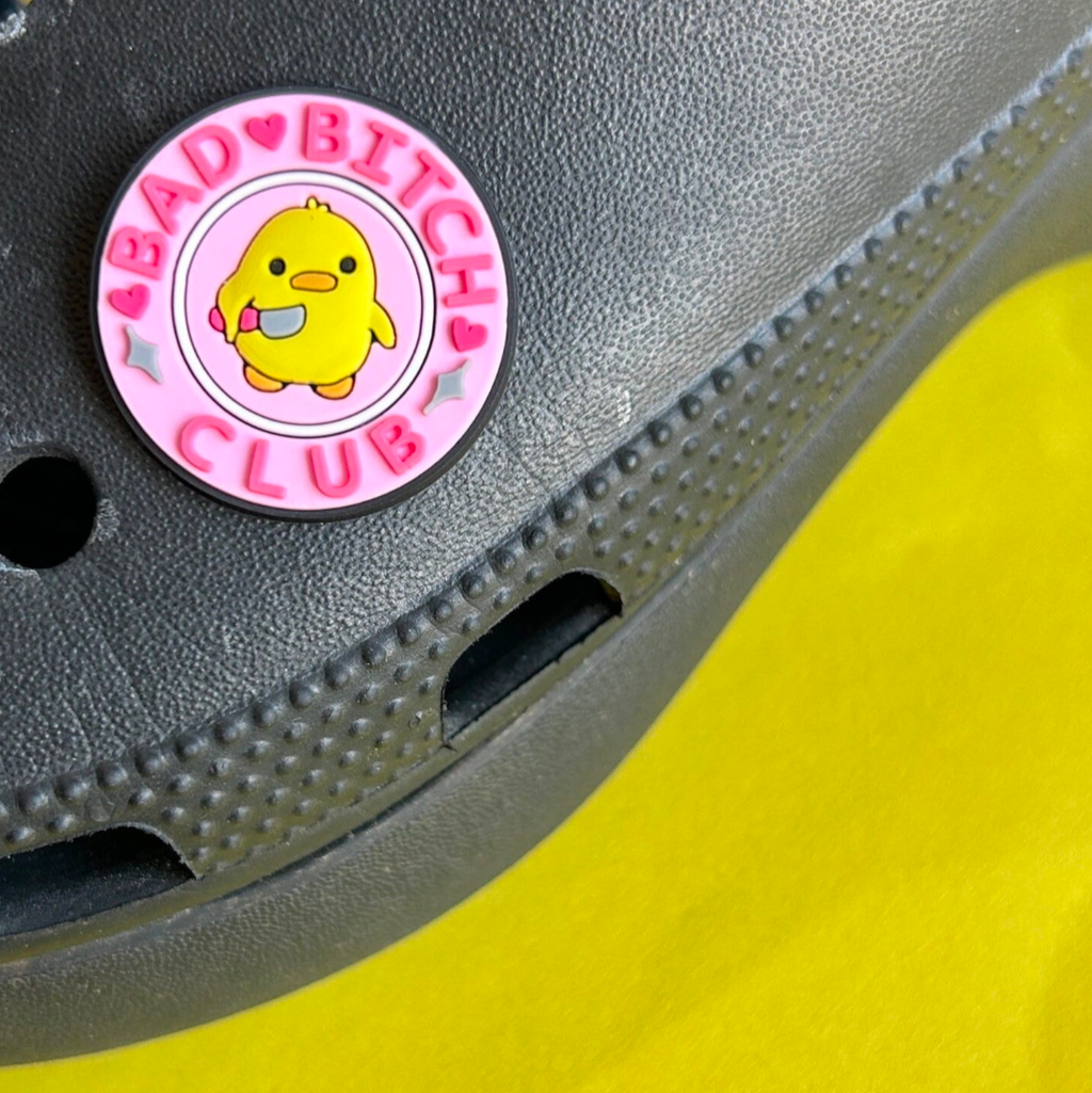Bad Bitch Club slogan croc like shoe charm. Shown on a black croc shoe. 