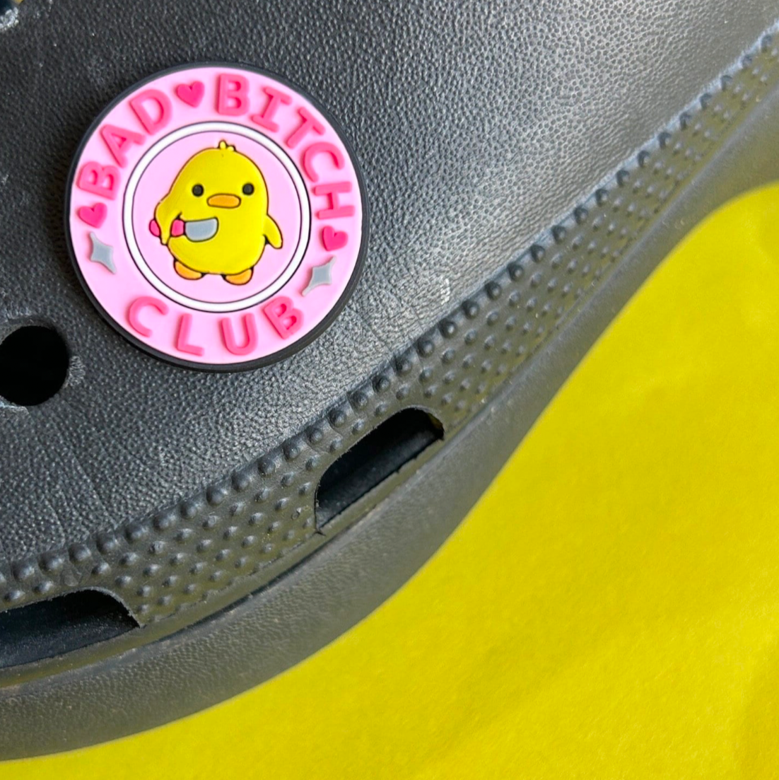 Bad Bitch Club slogan croc like shoe charm. Shown on a black croc shoe. 