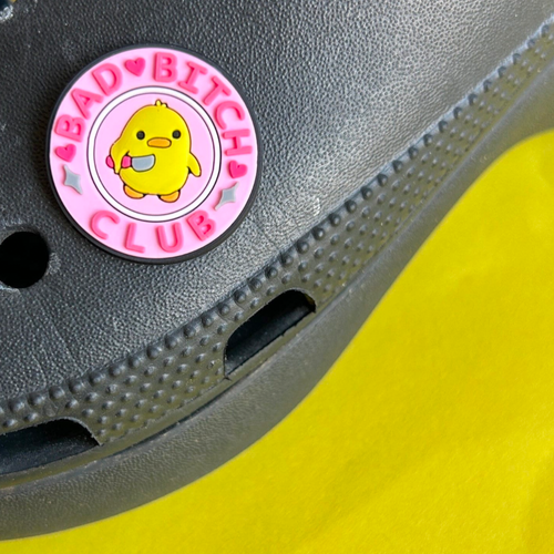 Bad Bitch Club slogan croc like shoe charm. Shown on a black croc shoe. 