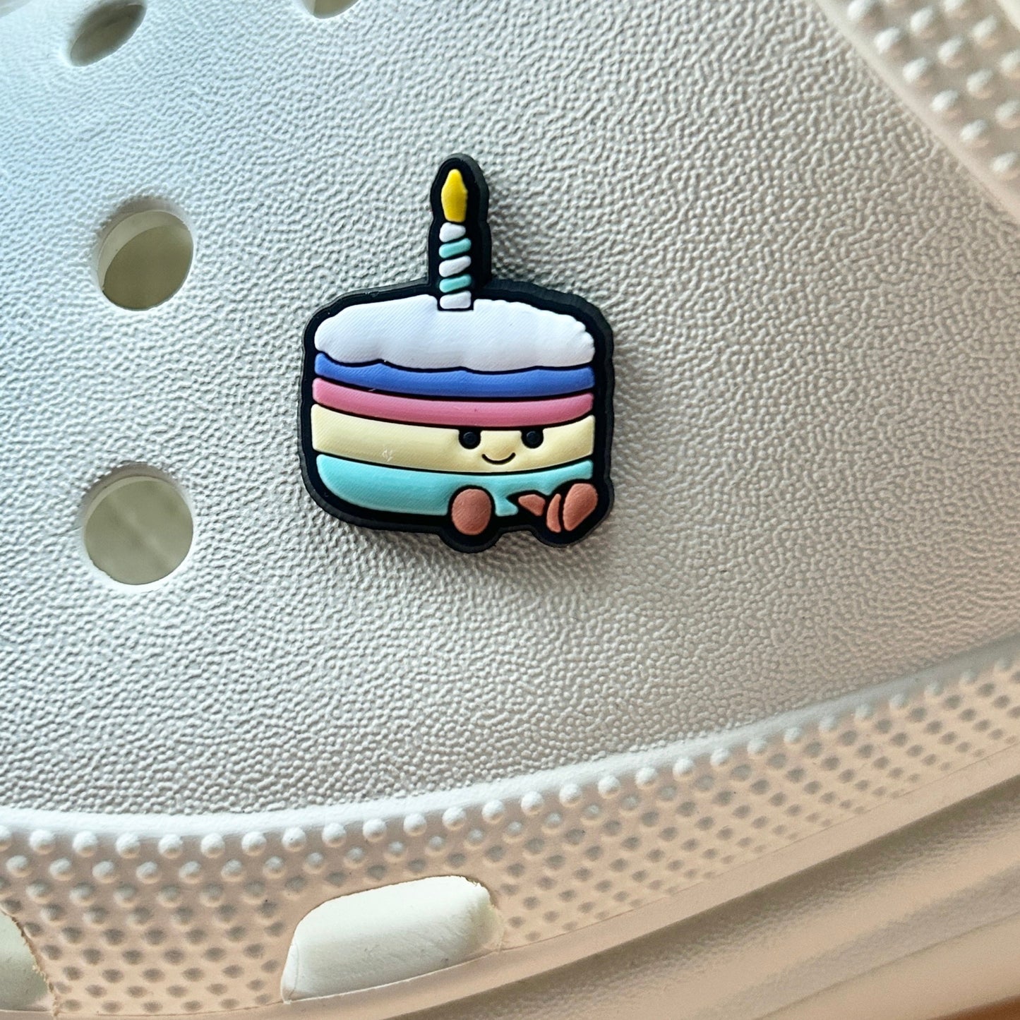 Birthday Cake croc like shoe charm. Shown on a cream croc shoe. 