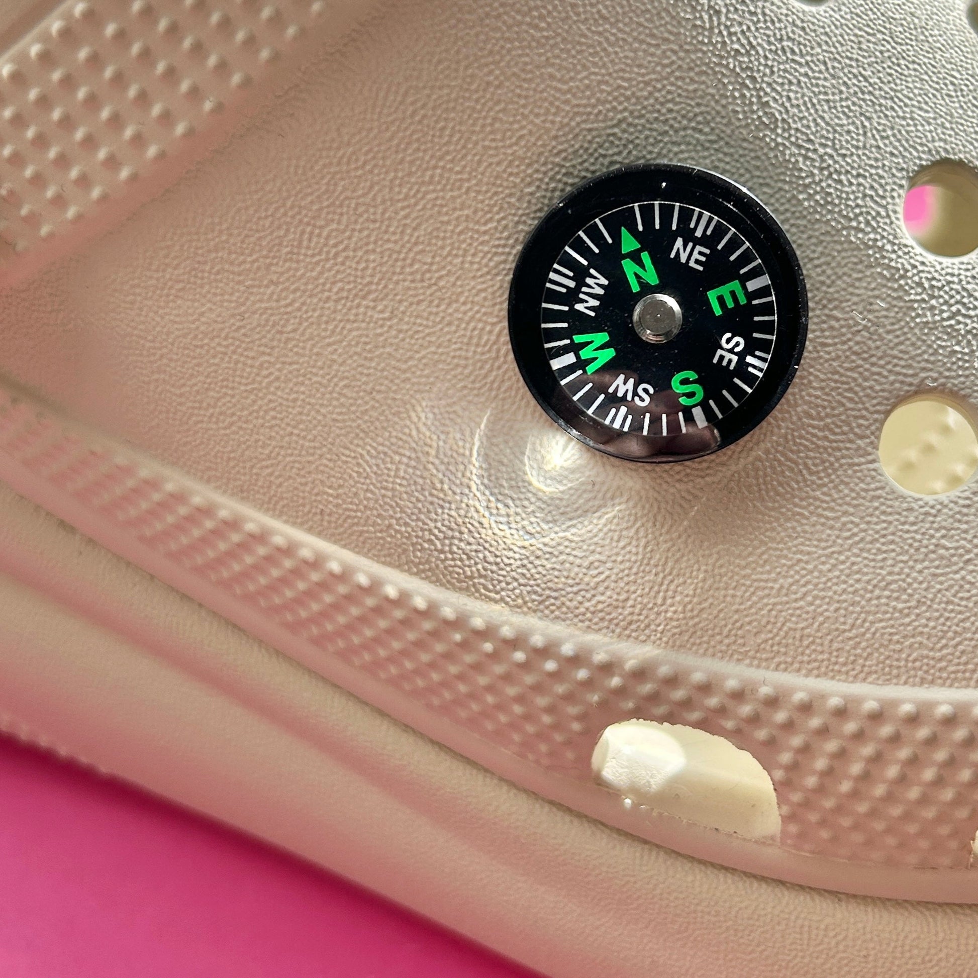 3D working compass croc shoe charm. Shown on a cream croc shoe. 