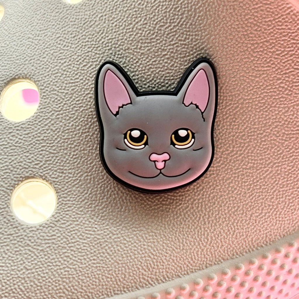 Grey Cat Face Croc charm. Shown on a cream croc shoe. 