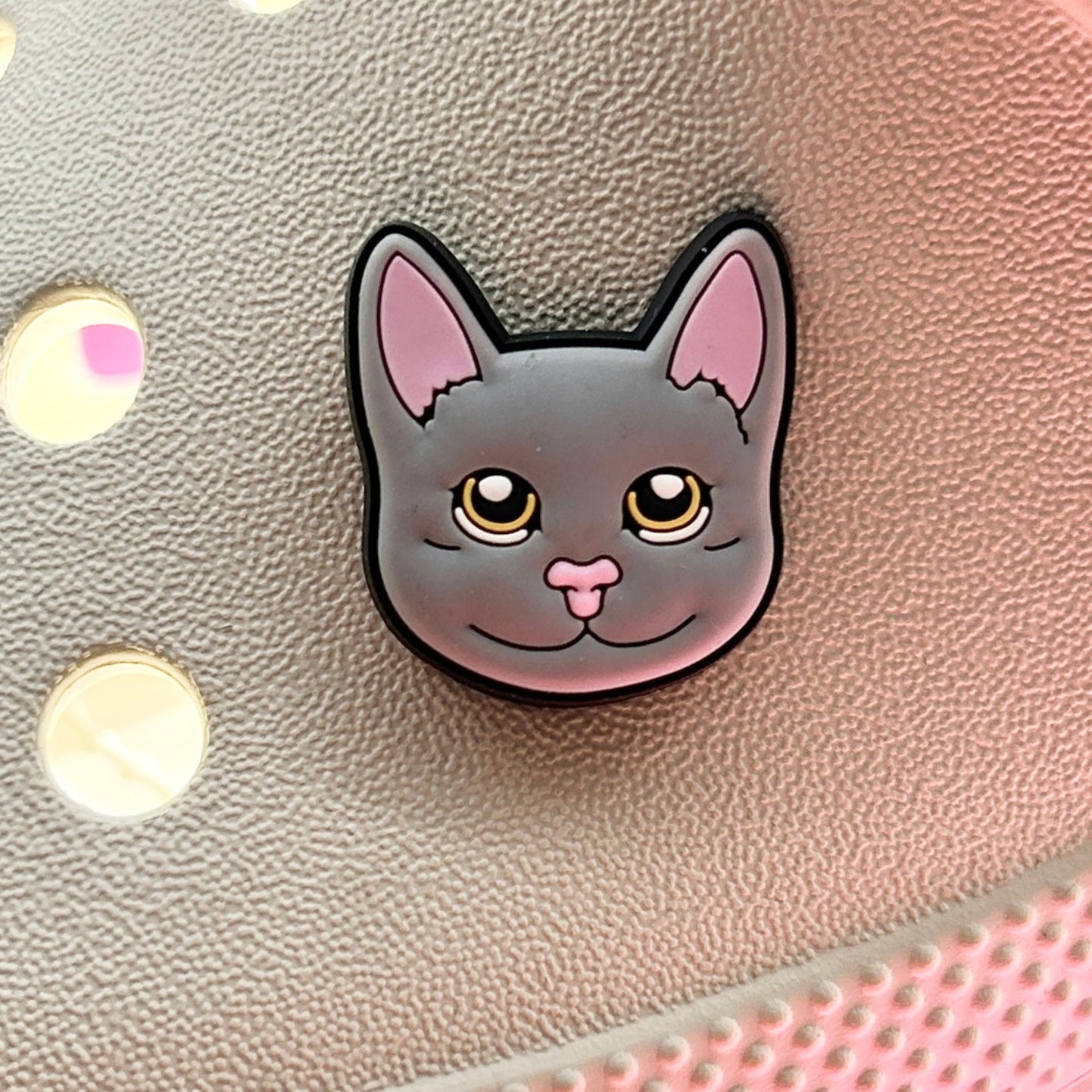 Grey Cat Face Croc charm. Shown on a cream croc shoe. 