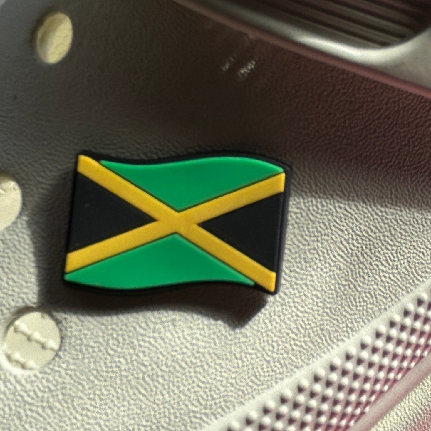 Jamaican Flag croc like shoe charm. Modelled on a cream croc shoe. 