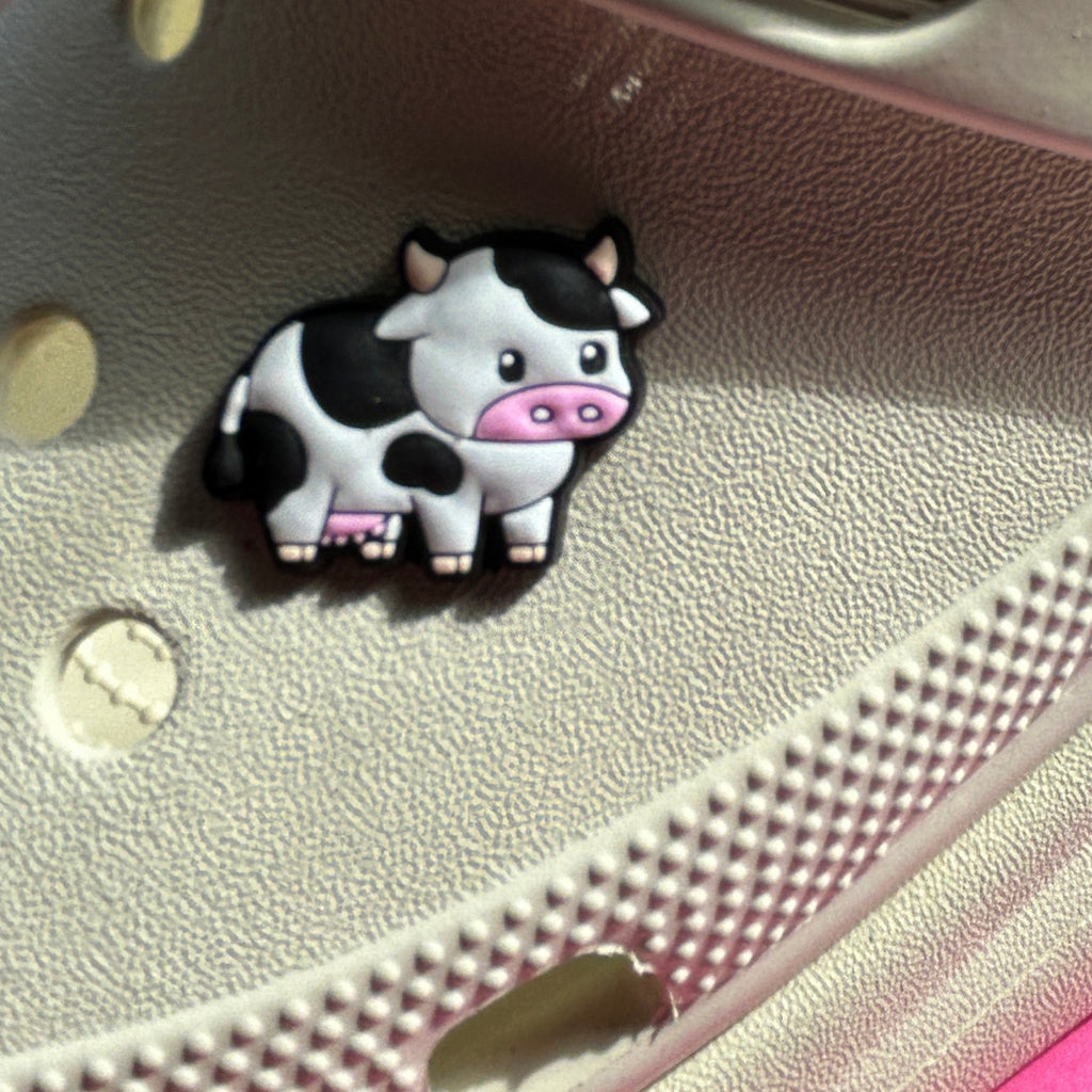 Black and white freesia cow croc shoe charm. Modelled on a cream croc shoe.