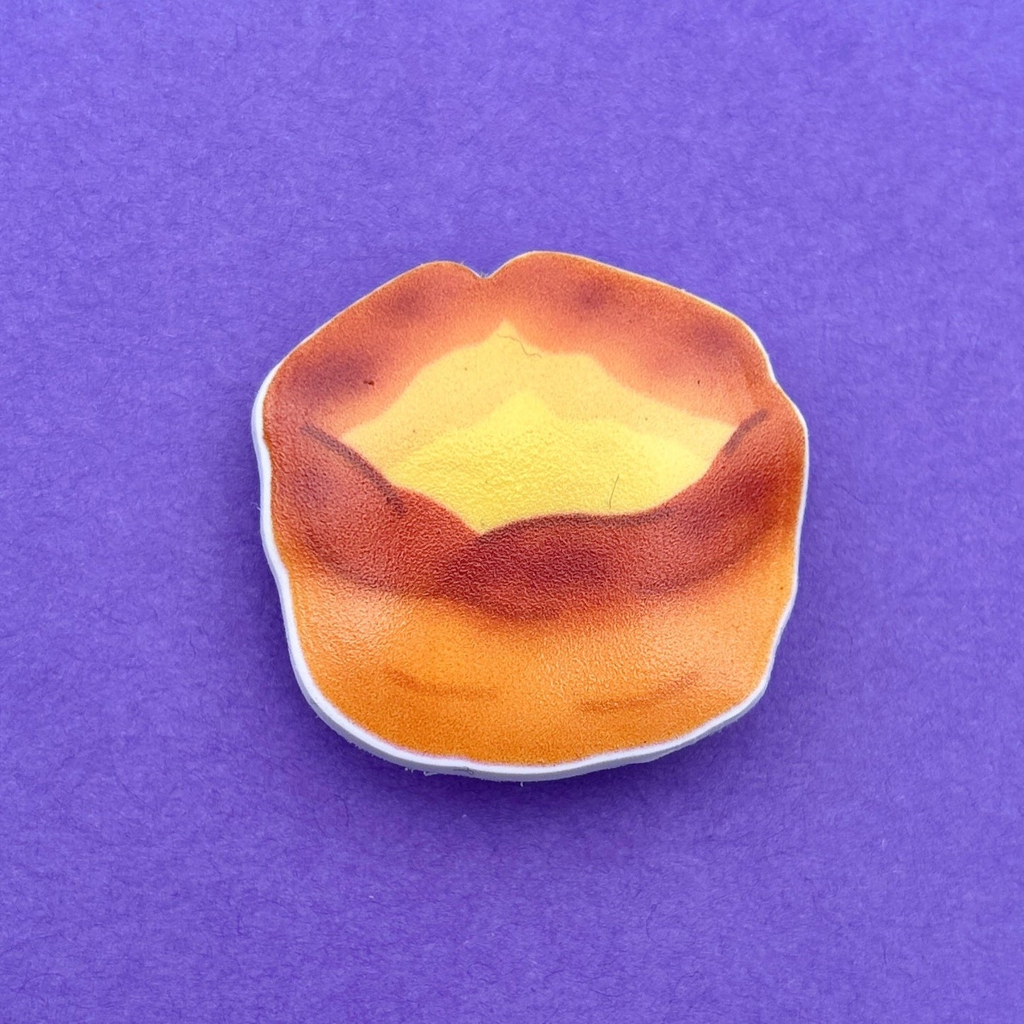 Yorkshire Pudding Croc like shoe charm. White background to charm. Photographed on a purple background for contrast. 