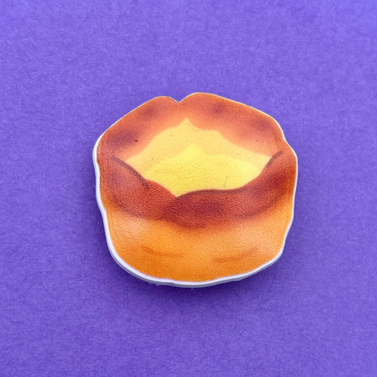Yorkshire Pudding Croc like shoe charm. White background to charm. Photographed on a purple background for contrast. 