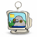 An embroidered keychain shaped like a retro computer monitor, featuring a gray pigeon with yellow eyes on a light blue screen background. The keychain has a white embroidered border, a silver metal split ring, and is shown on a clean white background.