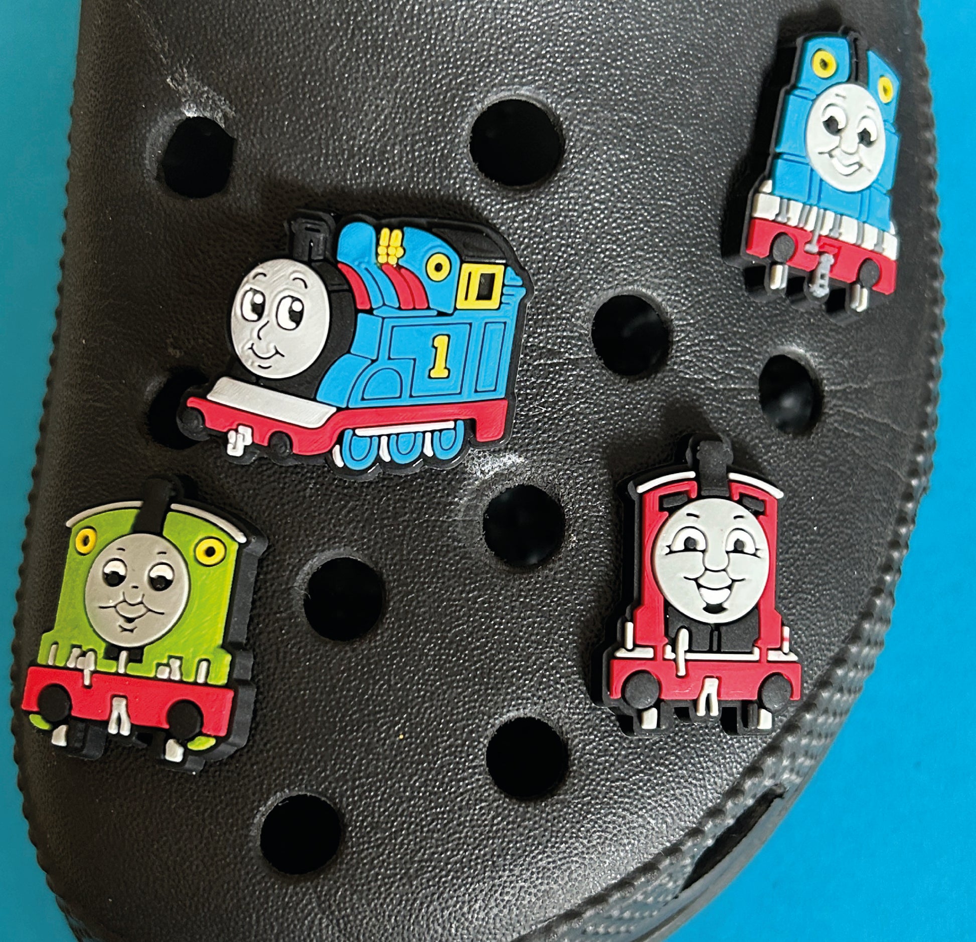 Collection of famous character trains on a croc shoe. 